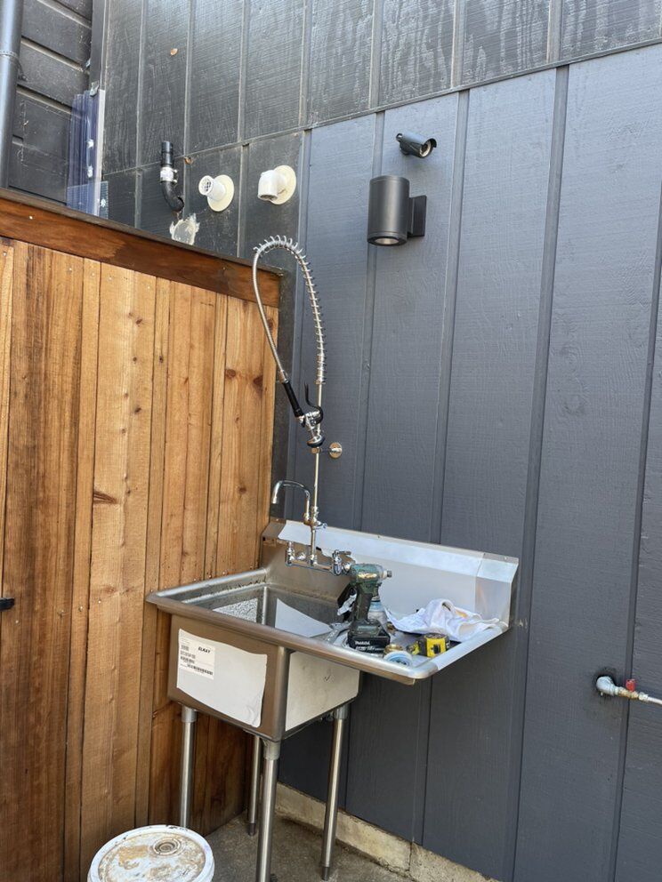 Stainless commercial sink with supply and drain connections